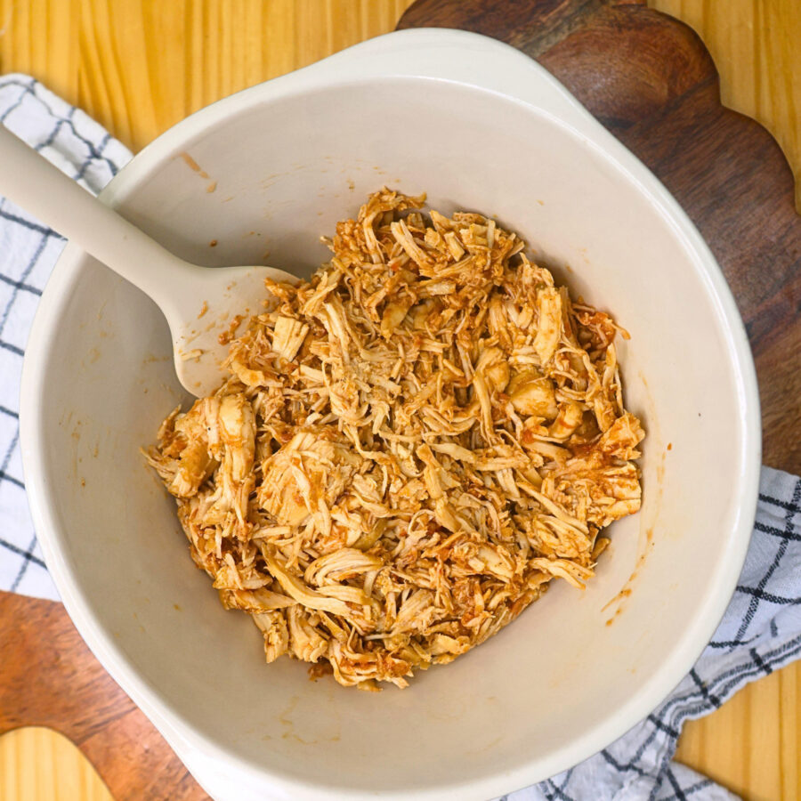 Cooked and shredded chicken with salsa and taco seasoning