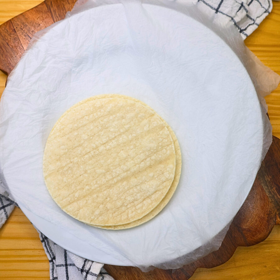 Corn tortillas on wet paper towels after being warmed