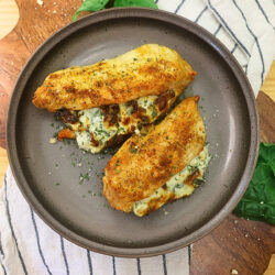 Overhead image of air fryer stuffed chicken breasts on a plate
