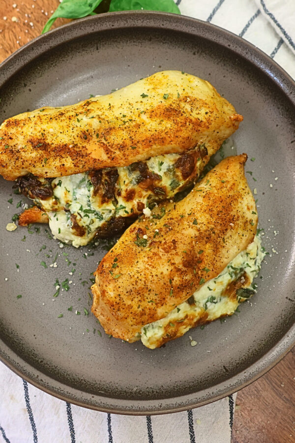 Overhead image of air fryer stuffed chicken breasts on a plate
