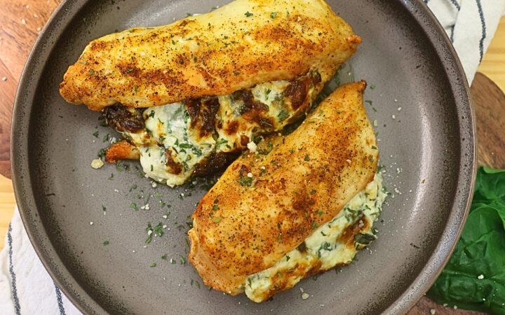 Overhead image of air fryer stuffed chicken breasts on a plate