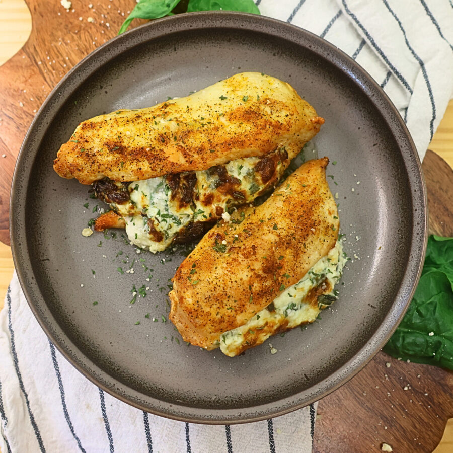 Overhead image of air fryer stuffed chicken breasts on a plate