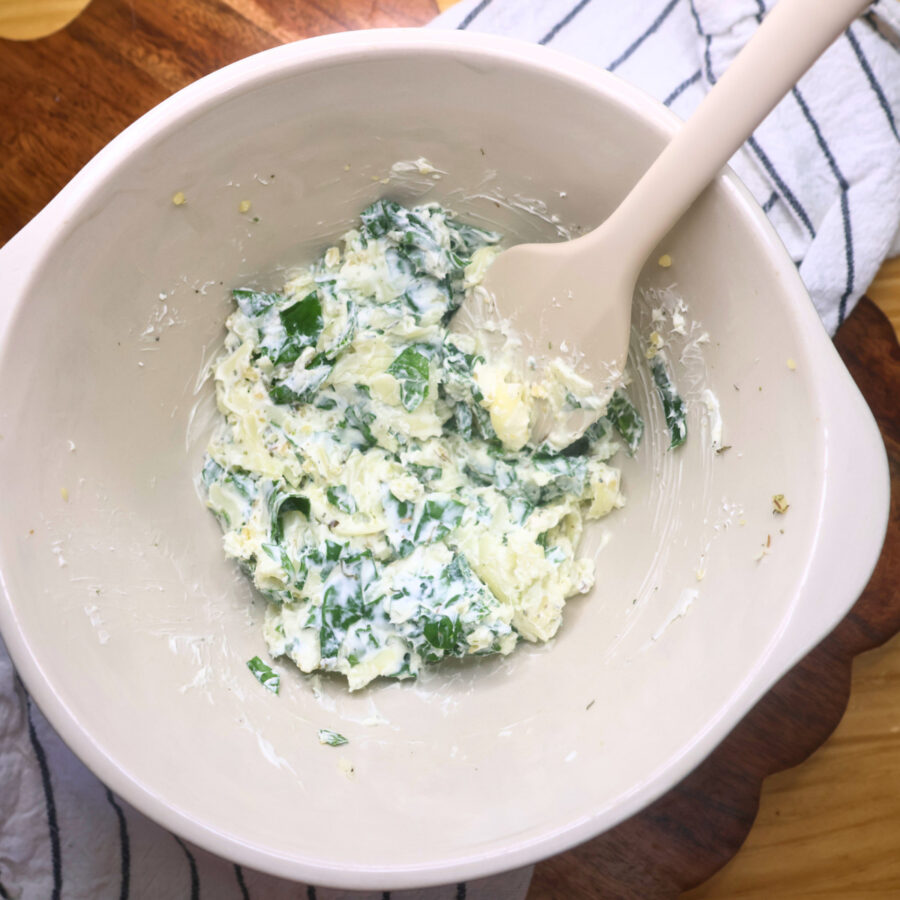Cream cheese and spinach filling mixed in a bowl