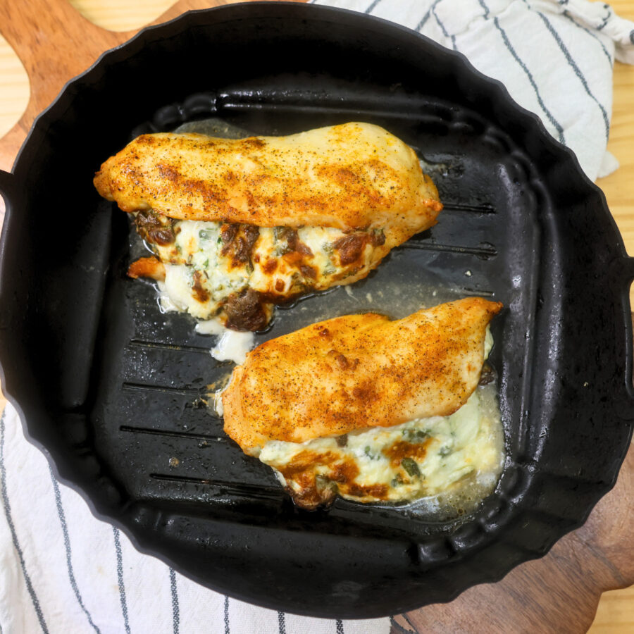 Overhead image of air fryer stuffed chicken breast in an air fryer basket