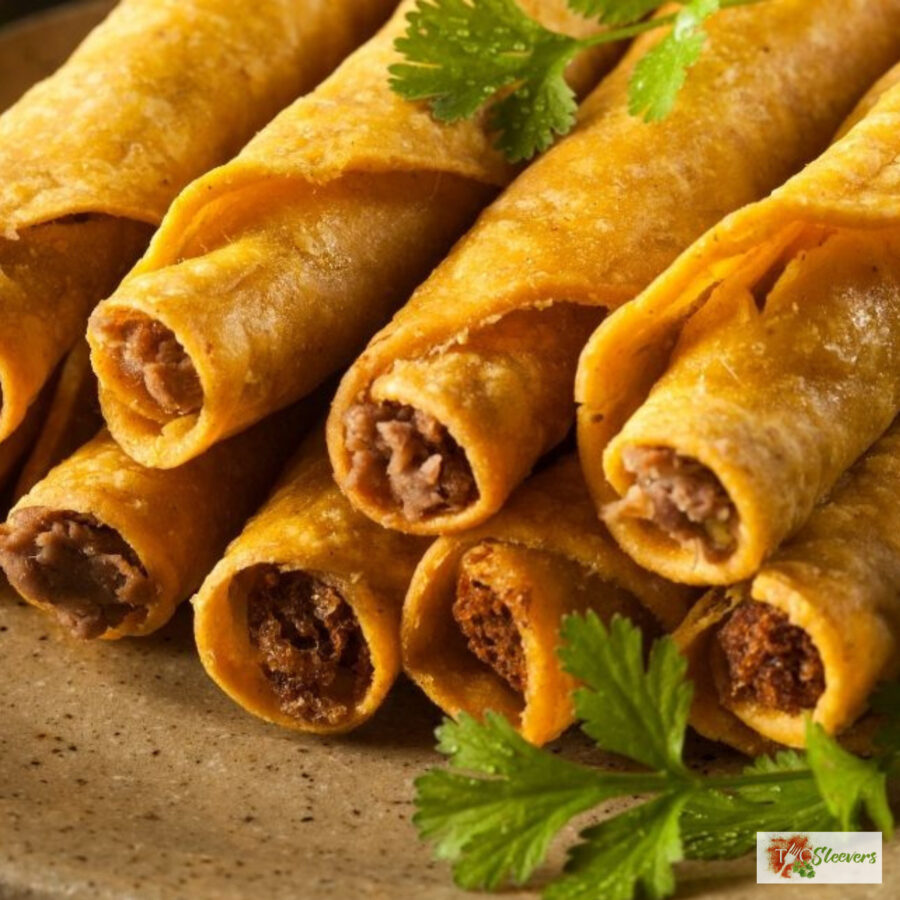 air fryer taquitos stacked on a plate with cilantro garnish