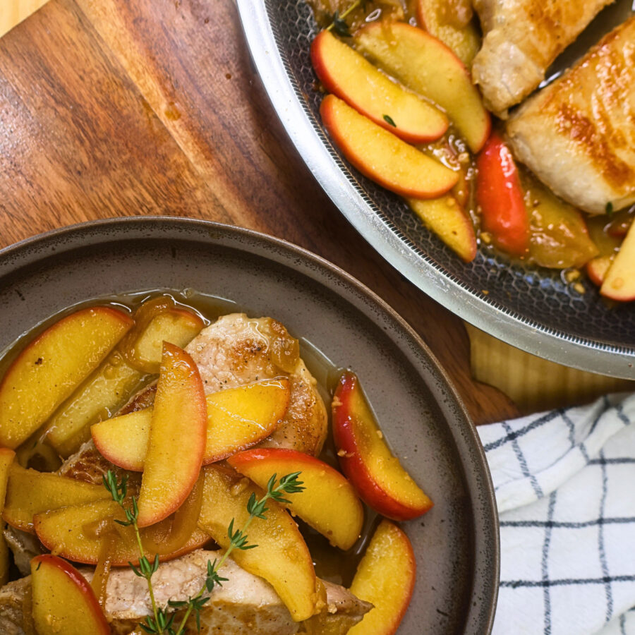 Plated Apple Pork Chops next to a skillet