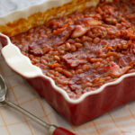 Baked Beans and Bacon in a red baking dish