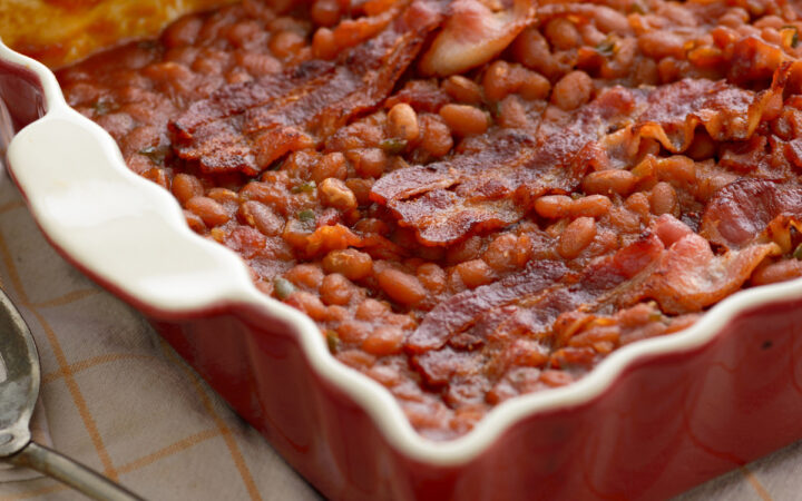 Baked Beans and Bacon in a red baking dish