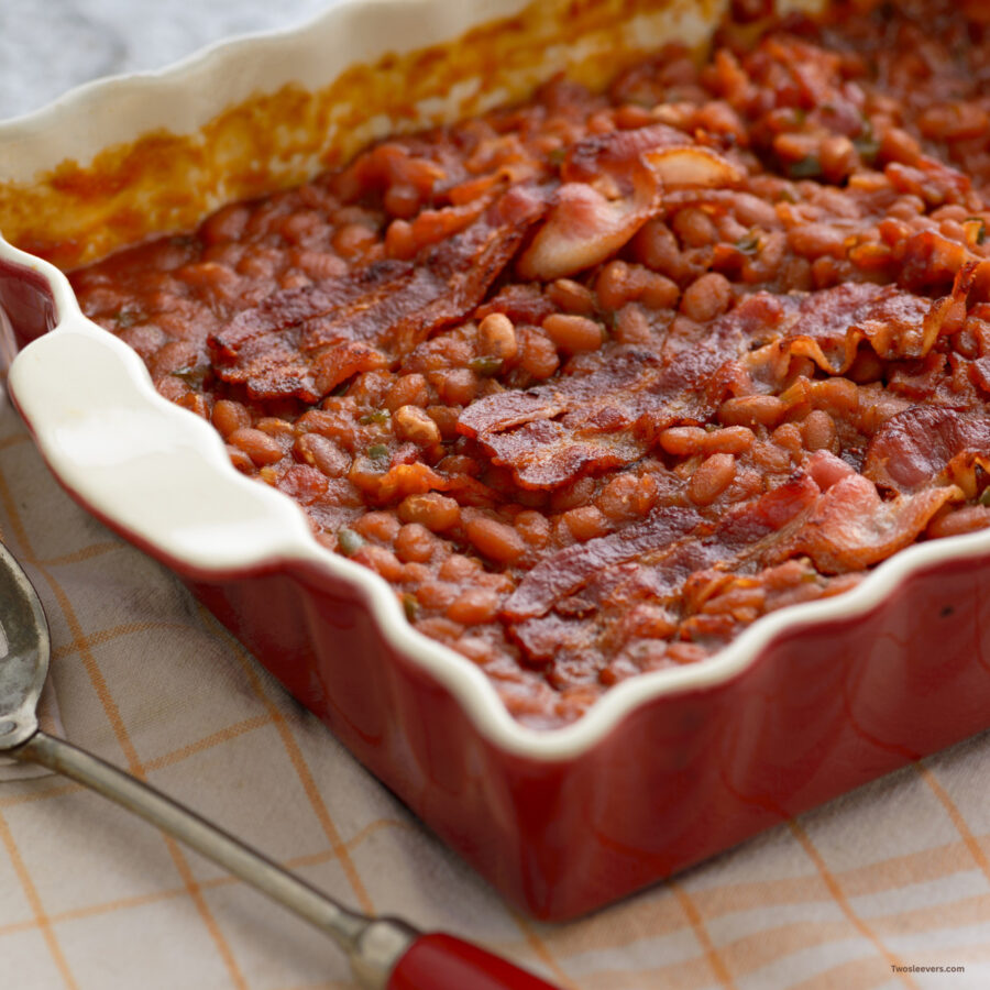 Baked Beans and Bacon in a red baking dish