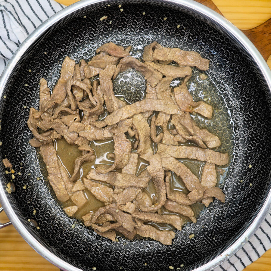 Cooked thin sliced steak in a skillet