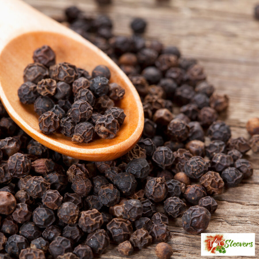 Close up image of Black Peppercorns on a serving spoon