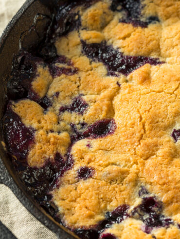 Close up image of Blueberry Cobbler in a cast iron pan