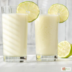 Two glasses of Brazilian Lemonade with lime garnish