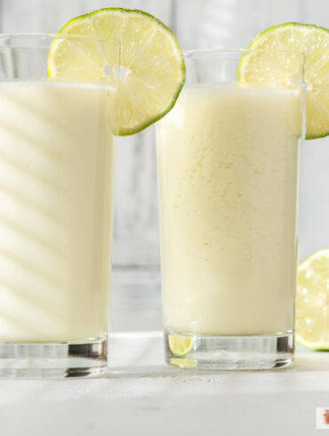 Two glasses of Brazilian Lemonade with lime garnish