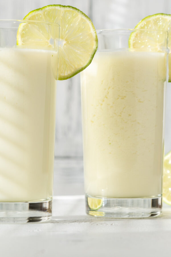 Two glasses of Brazilian Lemonade with lime garnish