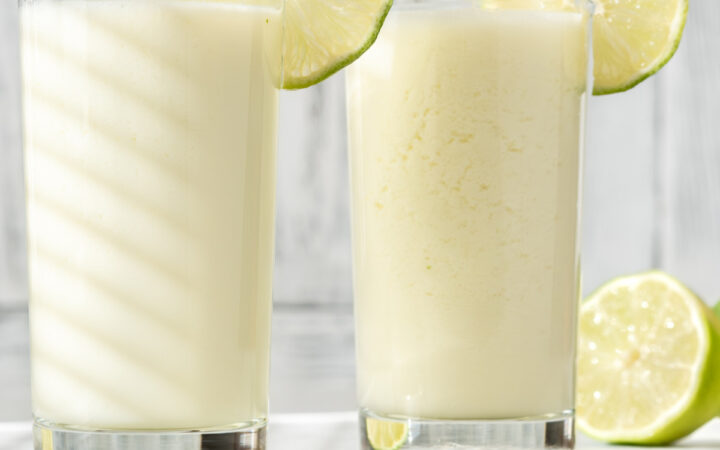 Two glasses of Brazilian Lemonade with lime garnish