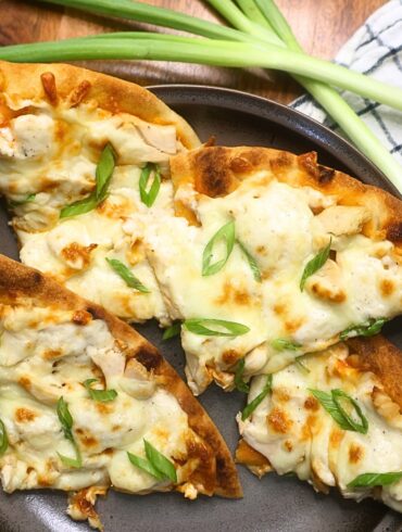 Four slices of Buffalo Chicken Flatbread Pizza on a plate