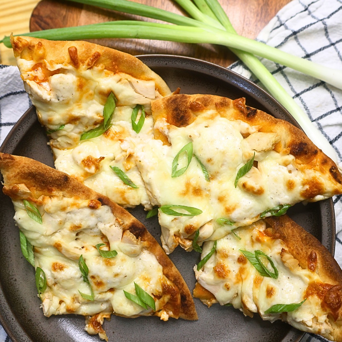 Four slices of Buffalo Chicken Flatbread Pizza on a plate