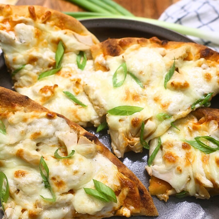 Close up image of slices of buffalo chicken flatbread pizza on a plate