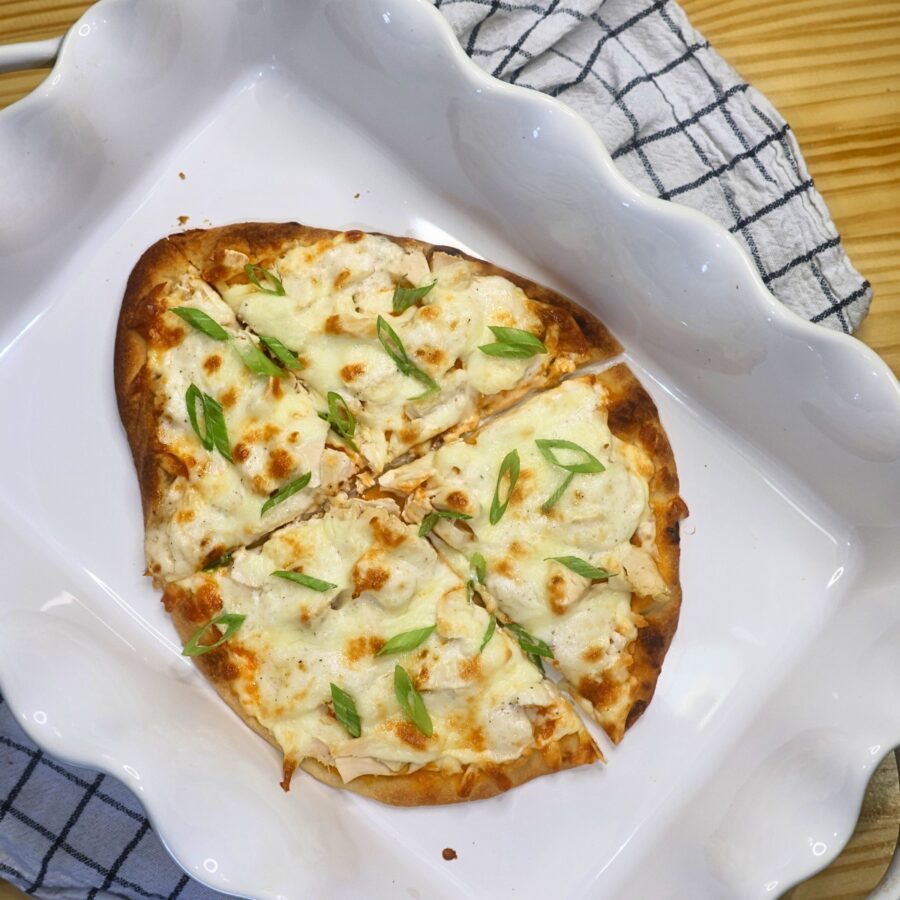 Buffalo Chicken Flatbread Pizza with green onions sliced into 4 pieces