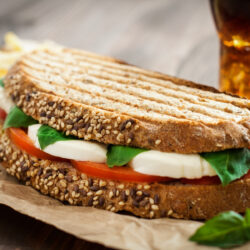 Basil Sandwich Close up image of a Caprese Sandwich