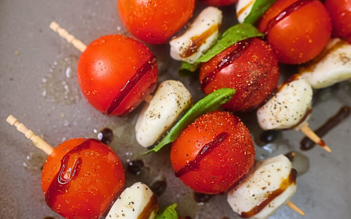 Close up image of Caprese skewers on a plate