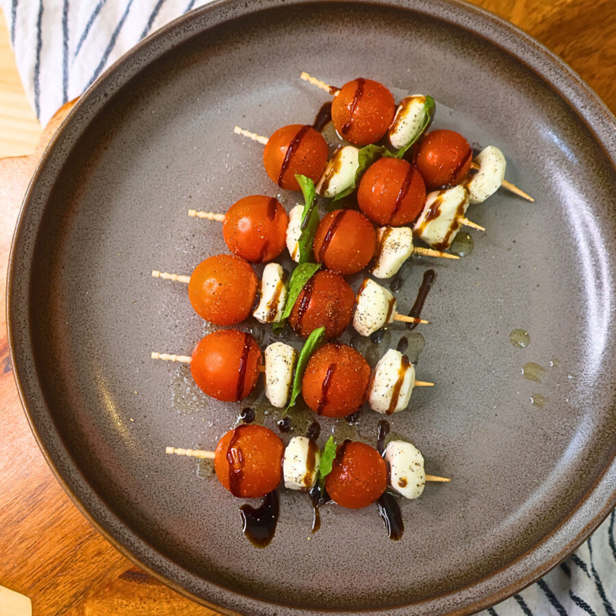 Caprese skewers with sauces and seasonings