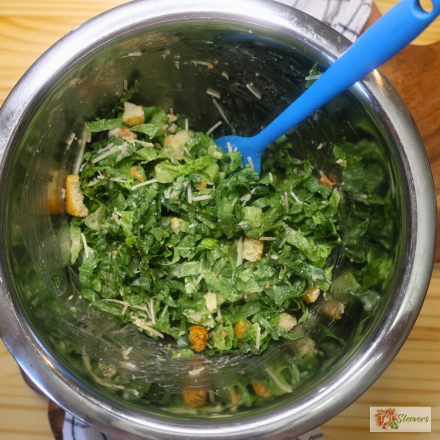Overhead image of a Caesar Salad in a mixing bowl