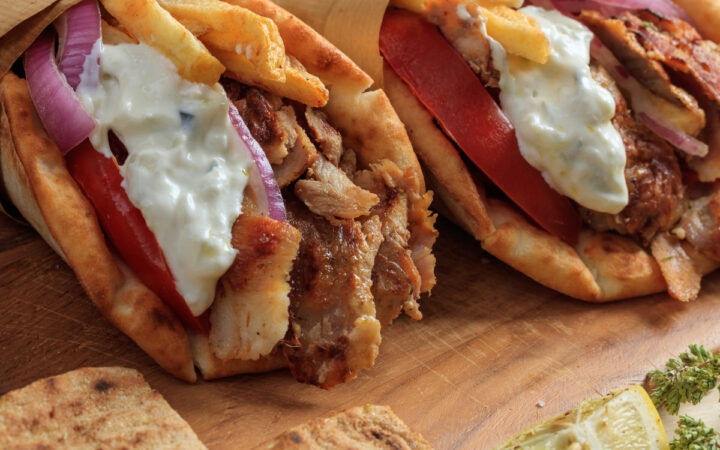 Two Chicken Gyros wrapped in parchment paper