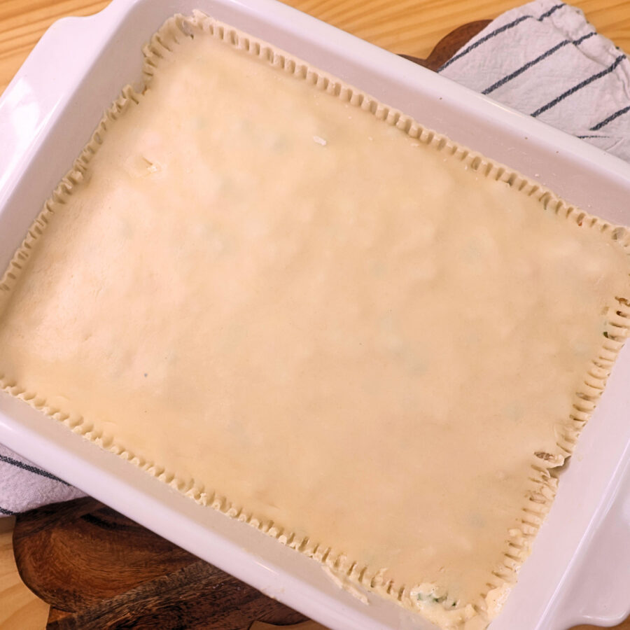 Chicken Pot Pie casserole assembled in a white baking dish but unbaked