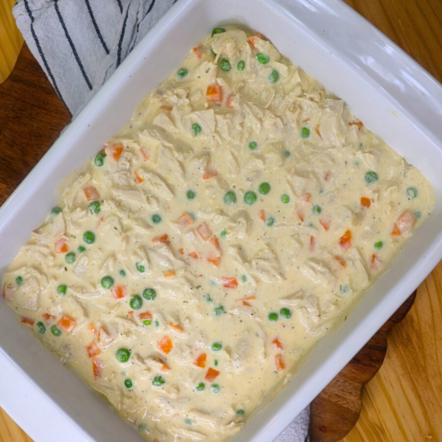 Chicken Pot Pie Filling in a white 9x13 casserole dish