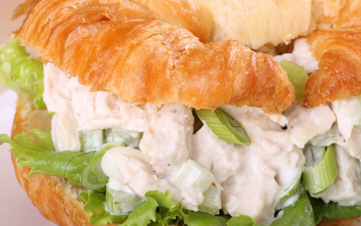 Close up image of chicken salad sandwich on a croissant