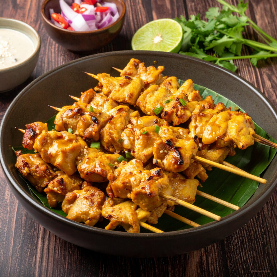 Chicken Satay Skewers on stacked on plate