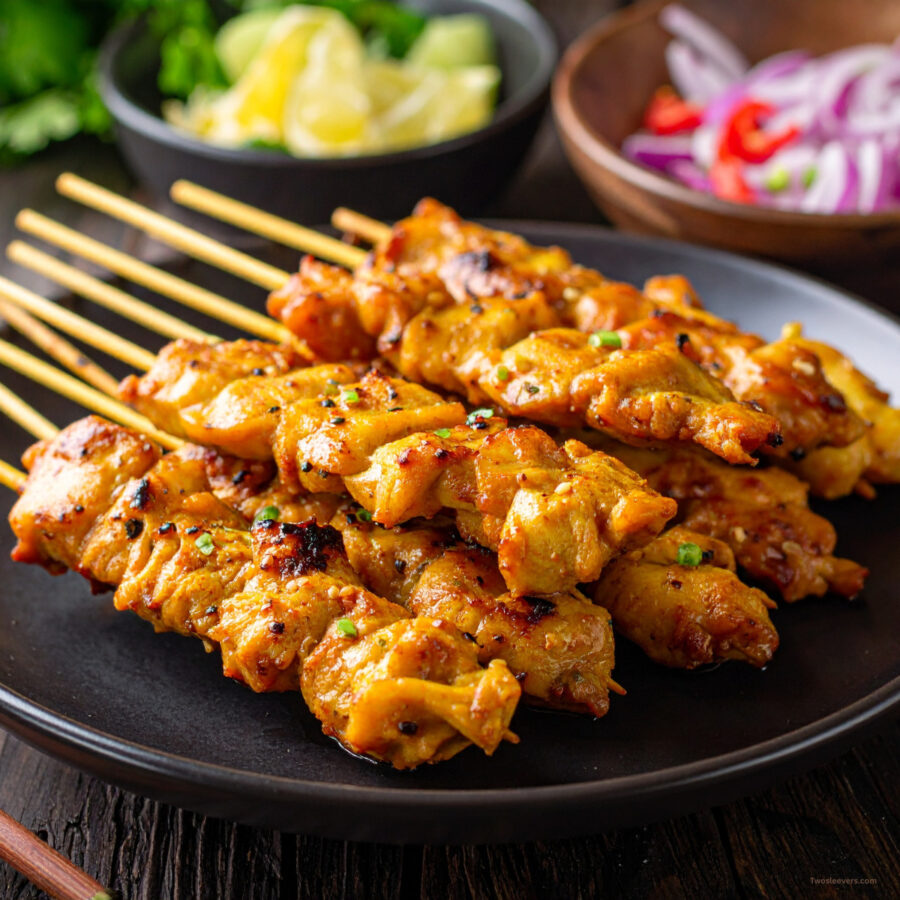 Close up image of Chicken Satay stacked on a plate