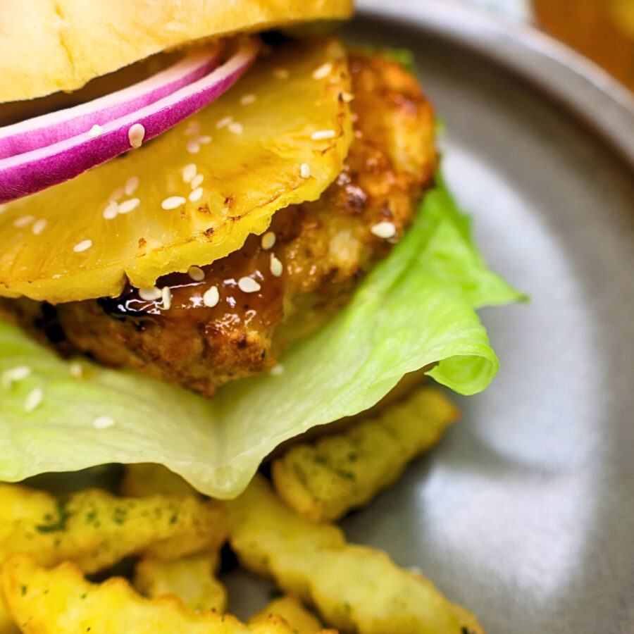 Close up image of Air Fryer Chicken Teriyaki Burger on a plate with fries