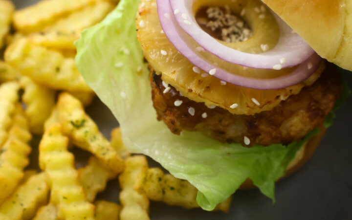 Assembled Air Fryer Chicken Teriyaki Burger on a plate with fries