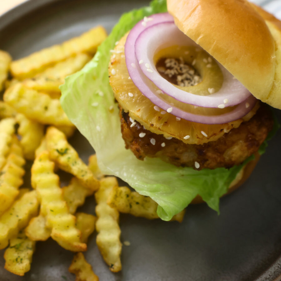Assembled Air Fryer Chicken Teriyaki Burger on a plate with fries
