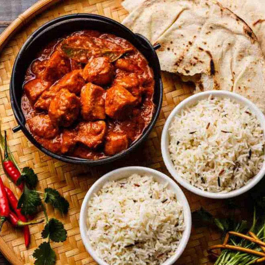 Instant Pot Chicken Tikka Masala in a bowl with rice on the side