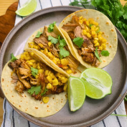 American television shows Overhead image of Chipotle Pork Carnitas on a plate with cilantro and lime