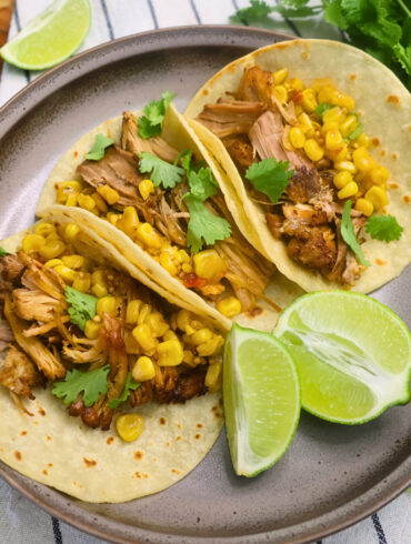 Overhead image of Chipotle Pork Carnitas on a plate with cilantro and lime