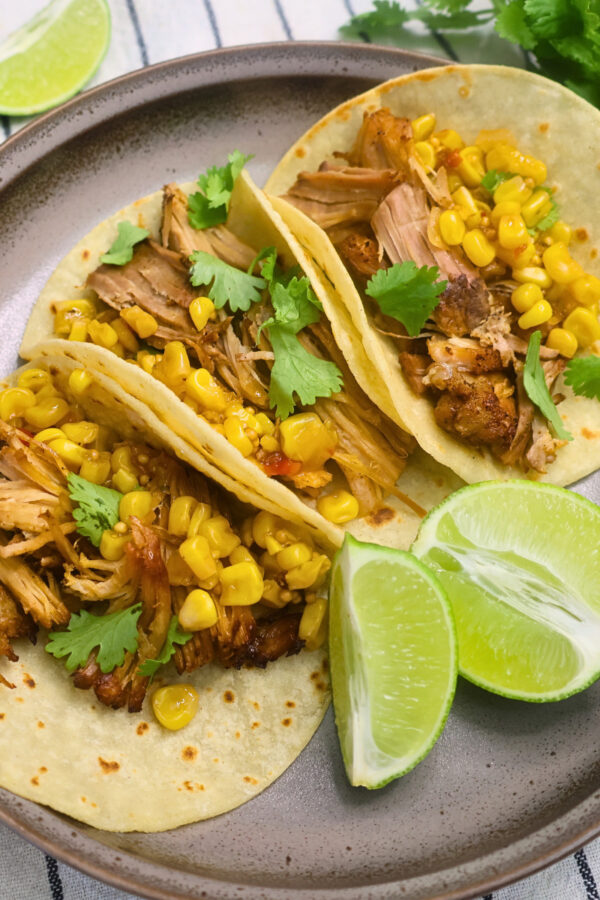Overhead image of Chipotle Pork Carnitas on a plate with cilantro and lime
