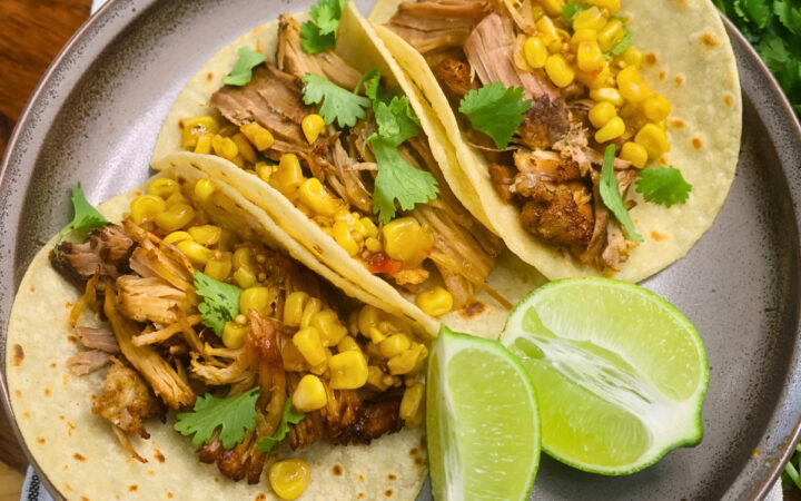 Overhead image of Chipotle Pork Carnitas on a plate with cilantro and lime