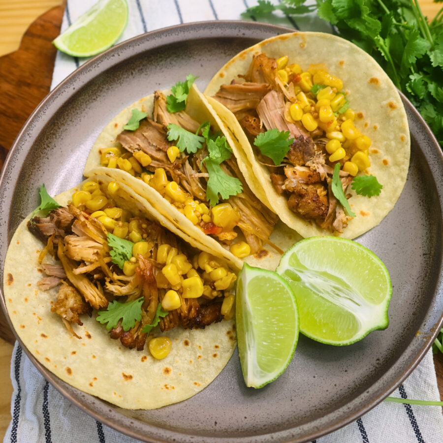Overhead image of Chipotle Pork Carnitas on a plate with cilantro and lime