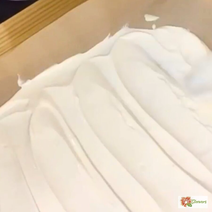 Sweetened Greek Yogurt being spread on parchment paper