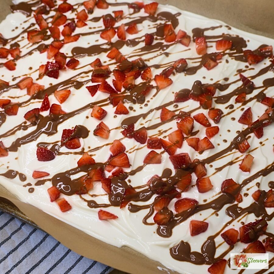 Greek Yogurt covered in diced strawberries and drizzled with melted chocolate