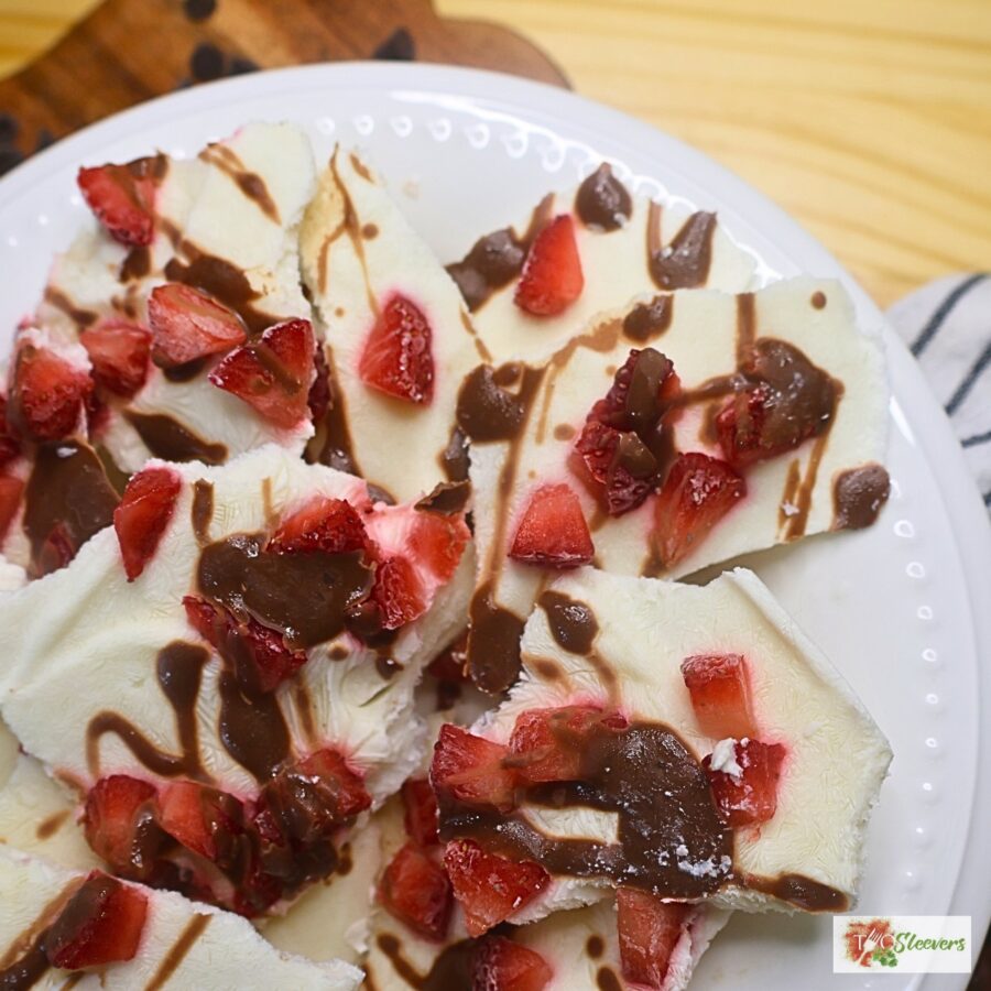 Close up image of chocolate strawberry yogurt bark in a bowl broken into pieces