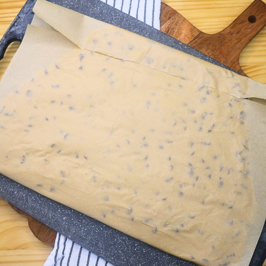 Cookie dough pressed flat in parchment paper