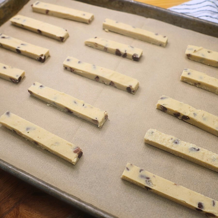 Unbaked cookie fries on a baking sheet lined with parchment paper