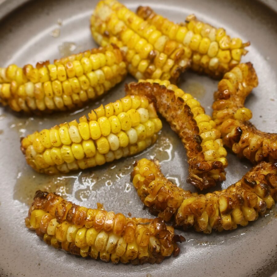 Corn ribs brushed with Cajun butter on a plate