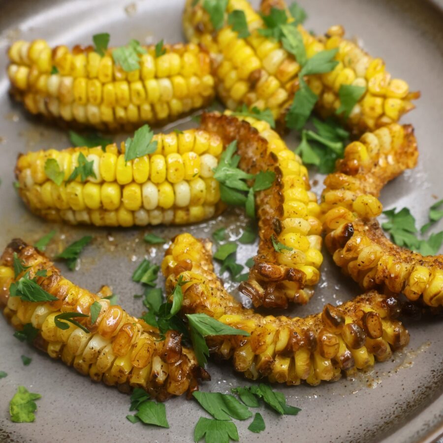 Cajun Butter Corn Ribs garnished with parsley and lemon juice